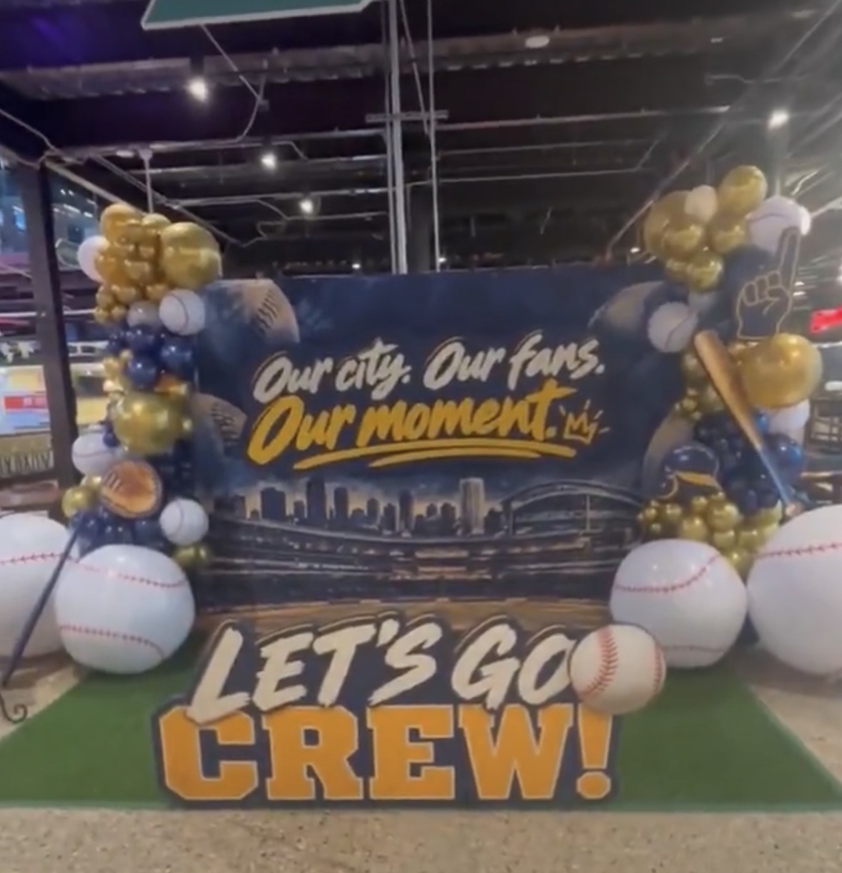 Brewers fan photo display at 3rd Street Market Hall reading “Our city. Our fans. Our moment.” and “Let’s go Crew!”
