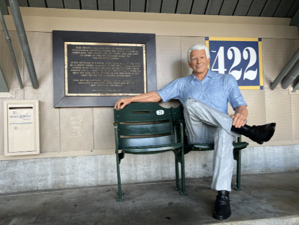 Bob Uecker Last Row statue beside an empty seat in Section 422